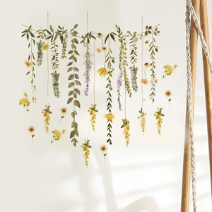 Detail of green vine wall stickers with eucalyptus leaves and small purple flowers