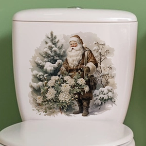Detail of Santa Claus and snowy pine tree decal on white ceramic toilet tank surface