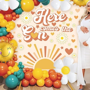 Detail of Here comes the Sun party backdrop with daisy balloons and warm sun theme