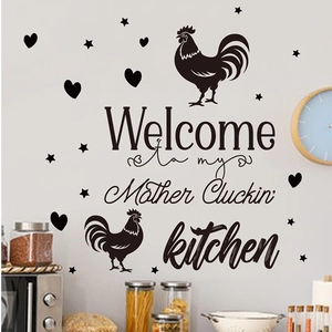 Detail of DIY PVC kitchen wall decal featuring rooster silhouettes and Mother Cluckin quote