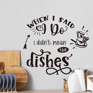 Detail view of black vinyl kitchen wall sticker with humorous English quotes on white wall