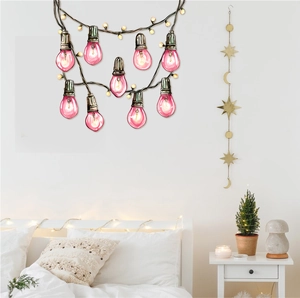 Pink light bulb string wall stickers shown in a cozy bedroom scene with star decor