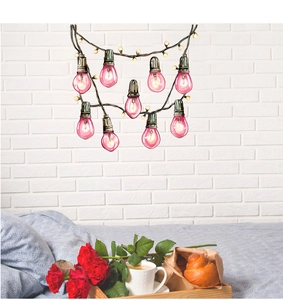 Detailed view of pink light bulb wall decals on a white brick bedroom background