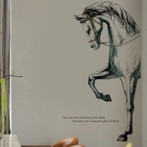 Detail of artistic horse sketch wall sticker with motivational text on grey wall