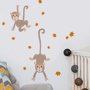Detailed view of monkey and maple leaf wall stickers on a clean nursery wall