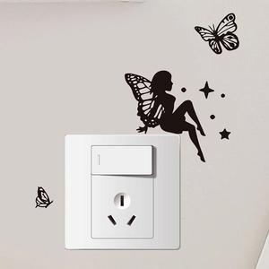 Detail of black butterfly fairy wall sticker applied around a square white light switch