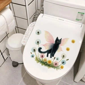 Detail of cartoon black cat with pink wings and dandelion sticker on a toilet lid