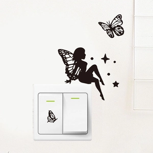 Detail of black silhouette fairy and butterfly PVC wall sticker on a white light switch