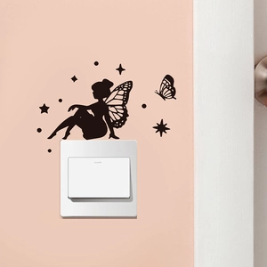 Detail of black silhouette fairy wall sticker around a white power switch on pink wall