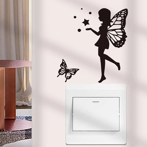 Detail of a black fairy and butterfly silhouette wall sticker on a white switch