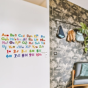 Detail of alphabet and numbers wall stickers with cute animals on a white nursery door