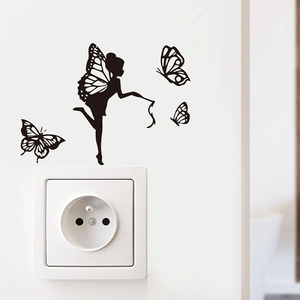 Close-up of black PVC butterfly fairy wall sticker applied above a white light switch