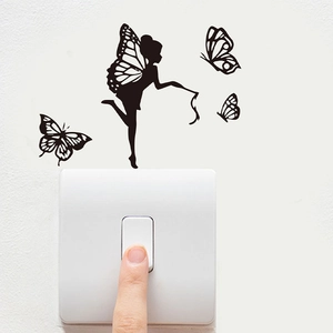 Detailed view of black vinyl fairy and butterfly decals applied around a light switch