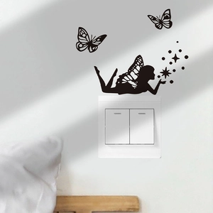 Detail of butterfly fairy wall sticker decoration around a light switch on white wall