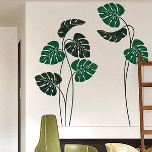 Modern Nordic style wall sticker featuring large green monstera leaves on a white wall