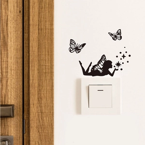 Detail of black fairy and butterfly silhouette wall sticker around a white light switch
