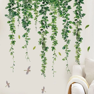 Detail of green vine wall decals with purple dragonflies on a minimalist white background