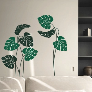 Detail of tropical monstera leaf wall stickers on a clean white living room wall background
