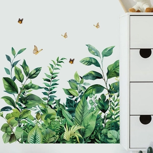 Tropical green leaves and butterfly wall decals applied on a clean white living room wall