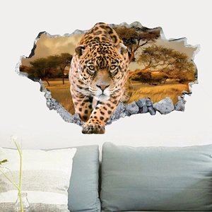 3D effect leopard breaking through wall decal displayed above a sofa in a modern living room