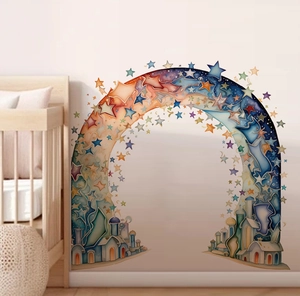 Detail of rainbow arch wall decal with stars and houses near a wooden crib