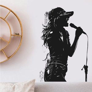 Detail of singing girl silhouette wall decal on a white bedroom wall with minimalist decor