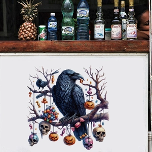 Detail of Halloween wall sticker with a black crow on dry branches and carved pumpkins