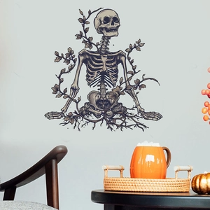 Macro detail of dark skull and vine PVC wall decal in a cozy home interior setting