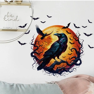 Detail of Halloween wall sticker with black crow, orange moon, and bats on white wall