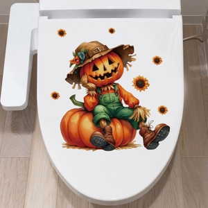 Close-up of a pumpkin scarecrow and sunflower sticker applied to a white toilet lid