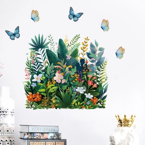 Detail of tropical green leaf wall stickers with colorful butterflies on a white wall