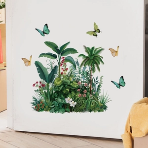 Detail of tropical palm leaves and butterflies wall stickers on white wall