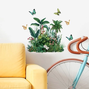 Detailed tropical wall stickers with palm leaves and colorful butterflies on a white wall