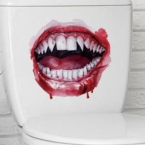 Close-up of Halloween bloody fangs wall sticker applied on a white ceramic toilet tank