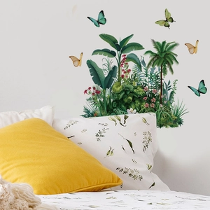 Detailed view of tropical leaf and butterfly wall stickers on a bedroom wall decoration