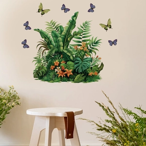 Detailed wall sticker showing tropical monstera leaves and colorful butterflies on a beige wall
