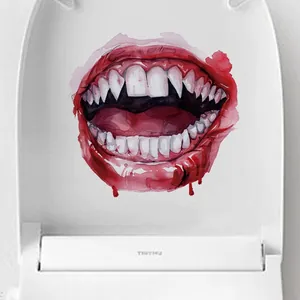 Detail view of Halloween monster mouth toilet sticker with fangs on a white lid