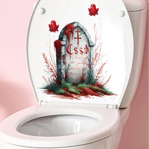 Close-up of Halloween toilet lid sticker with spooky tombstone and red ghosts design