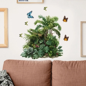 Detail of tropical monstera leaves and colorful butterflies wall decals on white wall