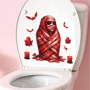 Detail of Halloween toilet seat stickers with red mummy, bats and ghosts on white surface