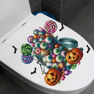 Macro shot of Halloween toilet lid decal with spooky eyeball candy and pumpkin motifs