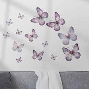 3D butterfly wall stickers with gold edges for home decor over a grey sofa