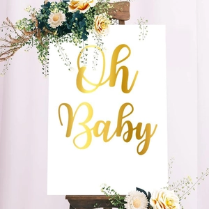 Elegant white and gold Oh Baby welcome sign on wooden easel for baby shower decor