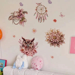Close-up of bohemian style pink owl and dreamcatcher wall stickers in a cozy nursery