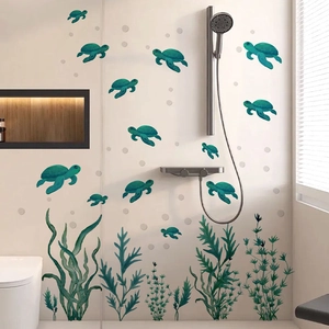 Detail of waterproof green sea turtle and seaweed wall stickers on white bathroom tiles