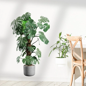 Lifelike artificial monstera potted plant in a gray minimalist planter for home decor
