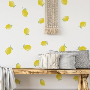 Detailed view of yellow lemon wall stickers with green leaves on a white living room wall