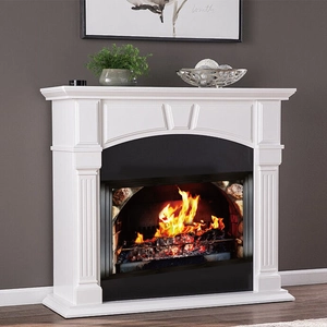 Detail of white European electric fireplace mantle with 3D carved pillars and 3D fire