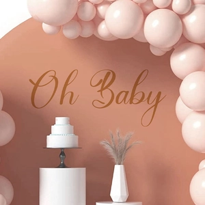 Brown Oh Baby wall decal for party backdrop with pink balloon arch and cake stand decor