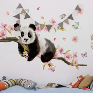 Nursery wall scene with panda on branch, pink blossoms and flags for child room decor